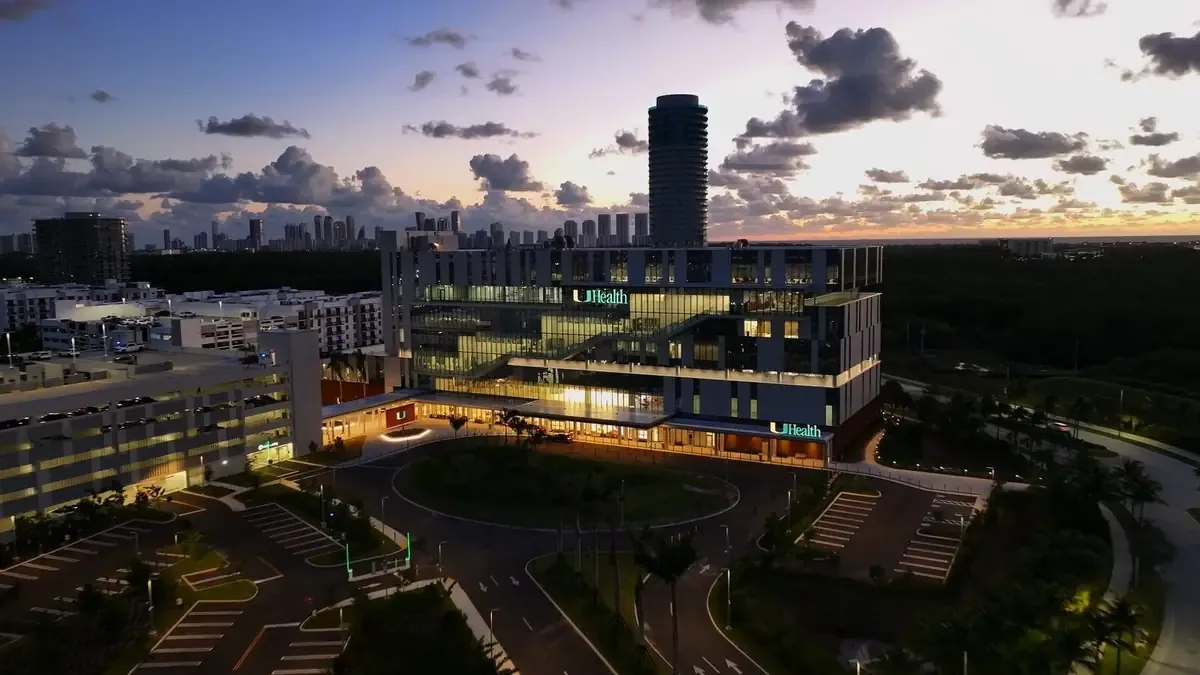 Aerial drone view of the UHealth medical campus and the Miami skyline at dusk
